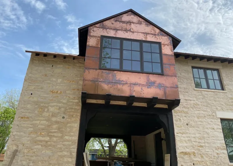 Copper metal panel facade on a stone building for Metal Roof Coating in Clemmons