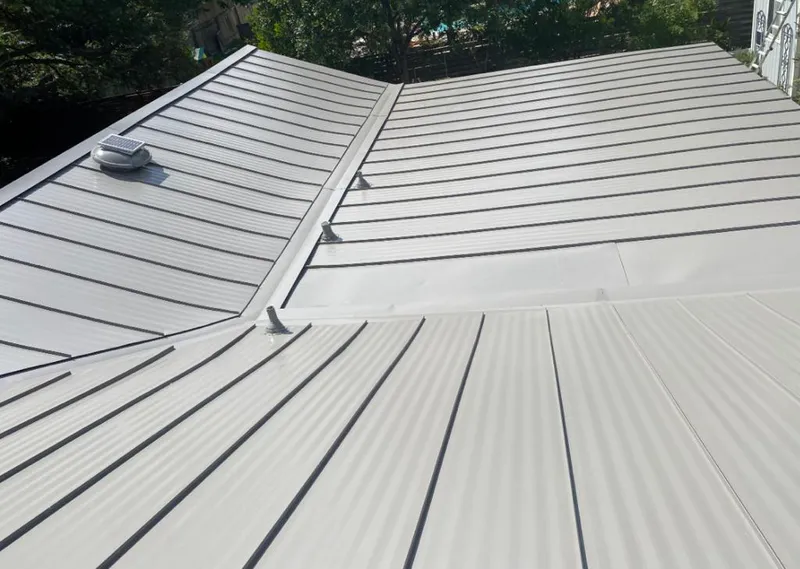 Solar attic fan installed on a metal roof for Roof Ventilation in Clemmons